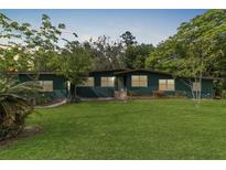 Charming single-story home with a large front lawn and mature trees enhancing its curb appeal at 11 Se 31St St, Ocala, FL 34471