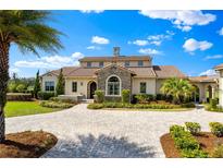 Stunning two-story home with a stone accent, manicured lawn, and a circular driveway at 12424 Sw 140Th Loop, Dunnellon, FL 34432