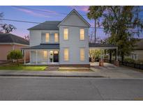 Charming two-story home boasting classic architecture, a covered porch, and a convenient carport at 30 Se Wenona Ave, Ocala, FL 34471