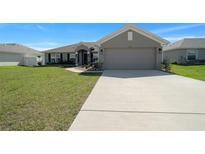 Charming single-story home featuring a spacious two-car garage and well-maintained front lawn at 5086 Sw 91St St, Ocala, FL 34476
