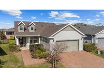 Charming single-Gathering home boasts two dormers, a brick driveway, and a well-manicured lawn at 5563 Nw 40Th Pl, Ocala, FL 34482