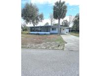 Charming single-story home with a spacious front yard and driveway at 5860 Sw 64Th Street Rd, Ocala, FL 34474