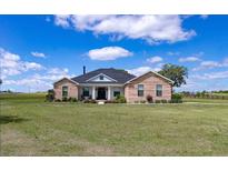 Charming single-story brick home with a manicured lawn, offering classic curb appeal and comfortable living at 7432 Ne 26Th Ave, Ocala, FL 34479