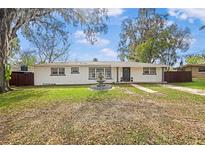 Charming single-story home with a well-maintained front yard and fountain feature under a mature tree at 1818 Se Lake Weir Ave, Ocala, FL 34471