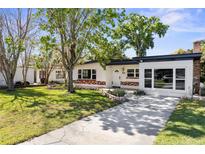 Charming single-story home featuring a well-maintained lawn and a long driveway leading to the entrance at 4133 Montrose Ct, Orlando, FL 32812