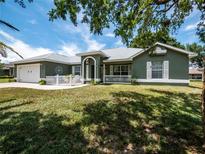 Charming single-story home with well-manicured lawn and inviting front porch at 4941 Nw 32 Street, Ocala, FL 34482