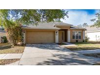 Charming single-story home with a two-car garage, neutral paint, and a well-maintained front yard at 5208 Sw 39Th St, Ocala, FL 34474