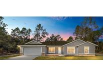Charming single-story home featuring a two-car garage and beautiful landscaping at 13180 Sw 80Th St, Dunnellon, FL 34432