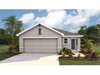 Charming single-story home featuring a two-car garage, neutral stucco siding, and freshly manicured landscaping at 2164 Ne 28Th Ln, Ocala, FL 34470