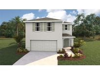 Two-story home with light gray siding, a two-car garage, manicured lawn, and stylish architectural details at 2170 Ne 28Th Ln, Ocala, FL 34470