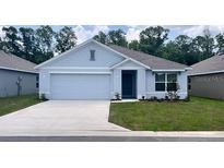 Charming one-story home featuring a two-car garage and well-manicured lawn at 2897 Ne 21St Terrace Rd, Ocala, FL 34470