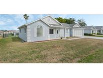 Charming single-story home with a well-maintained lawn and attached garage at 5347 Nw 20Th Pl, Ocala, FL 34482