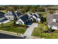 Stunning home with stone accents, well-manicured landscaping and a beautiful driveway at 7635 Nw 33Rd Pl, Ocala, FL 34482