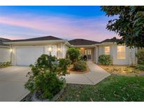 Charming home exterior featuring a well-manicured lawn and inviting walkway, showcasing curb appeal at 17959 Se 89Th Natchez Ave, The Villages, FL 32162