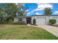 Charming one-story home with a well-maintained lawn and attached garage in a desirable neighborhood at 1902 Se 37Th Court Cir, Ocala, FL 34471