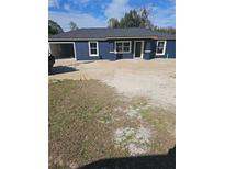 Newly constructed one-story home featuring a stucco exterior, contrasting trim, and an attached garage at 1929 Sw 7Th Pl, Ocala, FL 34474