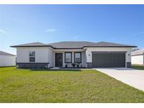Charming single-story home with a well-maintained lawn and two car garage at 3352 Sw 127Th Lane Rd, Ocala, FL 34473