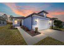 Charming one-story home boasts a well-manicured lawn, two-car garage, and inviting entryway at 5870 Sw 93Rd Cir, Ocala, FL 34481
