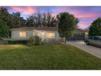 Charming single-story home featuring a well-manicured lawn, classic architectural details, and inviting curb appeal at 8740 Se 140Th Place Rd, Summerfield, FL 34491