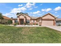 Charming single-story home with stucco exterior, well-manicured lawn, and mature landscaping at 12139 Se 91St Ter, Summerfield, FL 34491