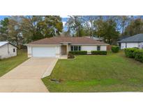 Charming single-story home featuring a well-manicured lawn and attached one car garage at 6718 Cherry Rd, Ocala, FL 34472