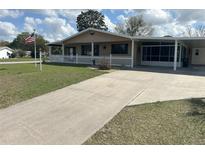 Charming single-story home features a covered porch, picket fence, and well-maintained lawn at 9140 Sw 103Rd Ln, Ocala, FL 34481