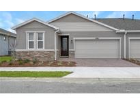 Charming one-story home featuring a two-car garage and stone accents on the facade at 5270 Nw 33Rd Pl, Ocala, FL 34482