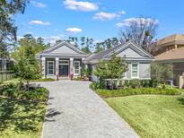 Beautiful single-story home with a well-manicured lawn and a patterned driveway leading to the front entrance at 8033 Nw 28Th St, Ocala, FL 34482