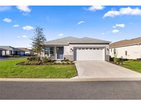 Charming single-story home with well-manicured lawn and a two-car garage on a sunny day at 8802 Sw 79Th Loop, Ocala, FL 34481