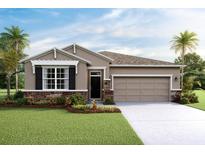 Charming single-story home boasts a manicured lawn, stone accents, and a convenient two-car garage at 3990 Nw 48Th Terrace Rd, Ocala, FL 34482