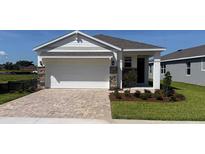 Charming single-story home with a two-car garage and stone accents and a brick paver driveway at 4040 Nw 44Th Cir, Ocala, FL 34482