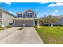 Charming two-story home featuring a well-manicured lawn and a two-car garage at 4401 Sw 52Nd Cir # 110, Ocala, FL 34474