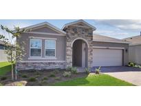 Charming single-Gathering home featuring a stone-accented entrance and a well-maintained front lawn at 4546 Nw 53Rd Avenue Rd, Ocala, FL 34482