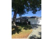 Well-maintained home featuring a two-car garage and manicured lawn at 509 Del Mar Dr, Lady Lake, FL 32159