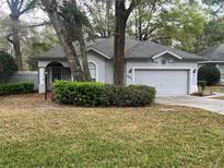 Charming one-story home with a well-maintained lawn and mature landscaping providing ample curb appeal at 8775 Sw 192 Ct, Dunnellon, FL 34432