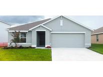 Charming single-story home with an attached two-car garage and a well-maintained front lawn at 7121 Se 113Th Ln, Belleview, FL 34420