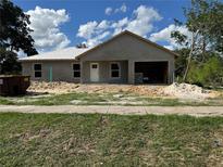 Unfinished single-Gathering home featuring an attached two-car garage in a residential neighborhood at 2147 Sw 3Rd St, Ocala, FL 34471