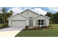 Charming one-story home with a well-manicured lawn, a two-car garage, and a covered front entry at 10036 Se 161St Lane Rd, Summerfield, FL 34491