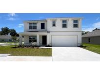 Charming two-story home with a spacious two-car garage and manicured front lawn at 15808 Se 101St Cir, Summerfield, FL 34491
