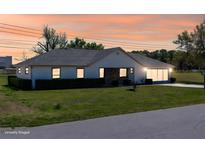 Charming single-story home featuring a well-manicured lawn and beautiful sunset sky at 3275 Nw 44Th Ct, Ocala, FL 34482