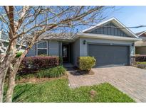 Charming single-Gathering home with a two-car garage, manicured landscaping, and a brick paver driveway at 3935 Nw 46Th Ter, Ocala, FL 34482