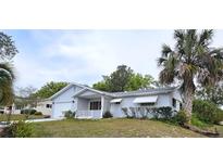 Charming single-story home featuring a well-maintained lawn and mature landscaping with a palm tree at 8449 Sw 106Th Pl, Ocala, FL 34481