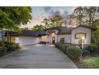 Inviting single-story home with a well-manicured lawn, a two-car garage, and ample parking space on the driveway at 8869 Sw 194Th Ct, Dunnellon, FL 34432