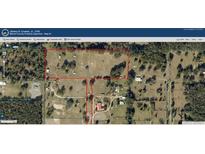 Aerial view of the property showcasing the expansive land and wooded areas at 10750 Nw 7Th St, Ocala, FL 34482