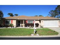 Charming home featuring well-maintained landscaping and an attached two-car garage at 13780 Sw 111Th Ave, Dunnellon, FL 34432