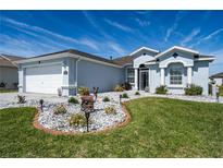 Charming single-story home with a well-manicured lawn and a decorative rock garden with a deer statue at 1813 Sw 157Th Place Rd, Ocala, FL 34473