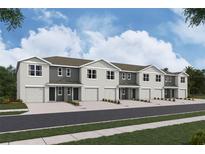 Charming row of townhomes featuring attached garages and neutral-toned exteriors at 3282 Bertram Rd, Wildwood, FL 34785