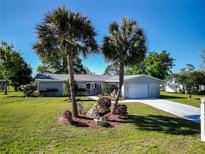 Charming single-story home boasts lush landscaping, palm trees, and a well-maintained lawn, curb appeal at 6398 Sw 108Th St, Ocala, FL 34476