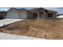 Charming single-story home with a two-car garage, neutral paint, and a lawn ready for landscaping at 71 Nw 42Nd Pl, Ocala, FL 34475