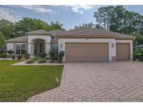 Charming single-story home with a three-car garage and well-manicured front lawn at 9509 Se 124Th Loop, Summerfield, FL 34491